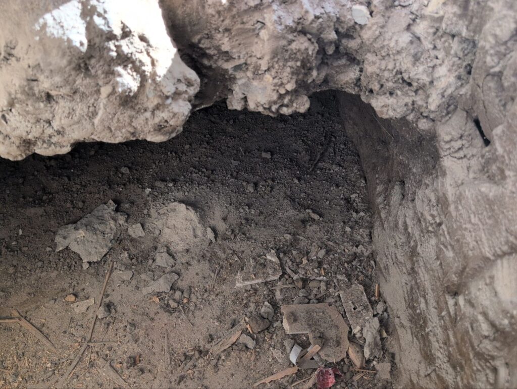 Excavation at the base of a wall during repair after a car crashed into a house