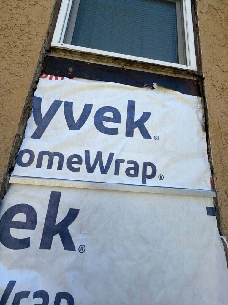 New house wrap installed on an exterior wall before new siding goes on