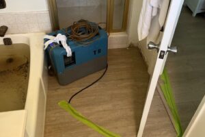 Bathroom set up with a dehumidifier during sewage backup cleanup in Encino
