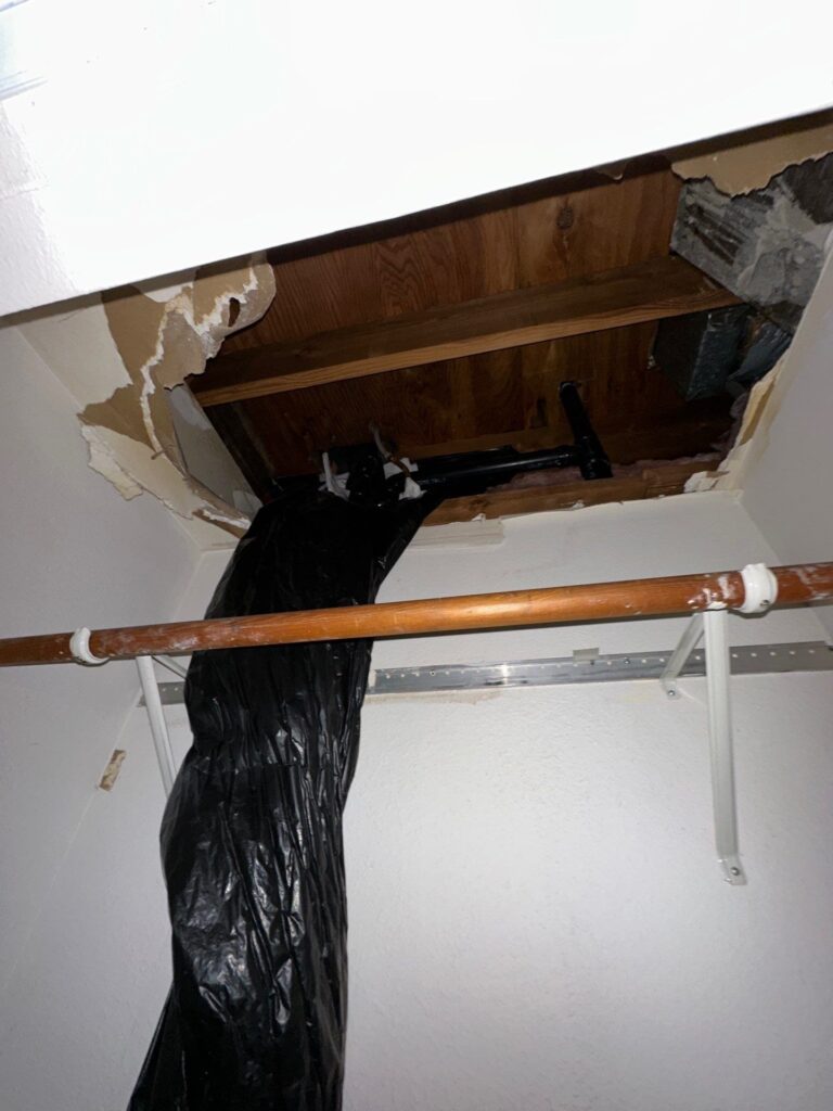 Closet ceiling opened to check water damage on the ceiling from the unit upstairs