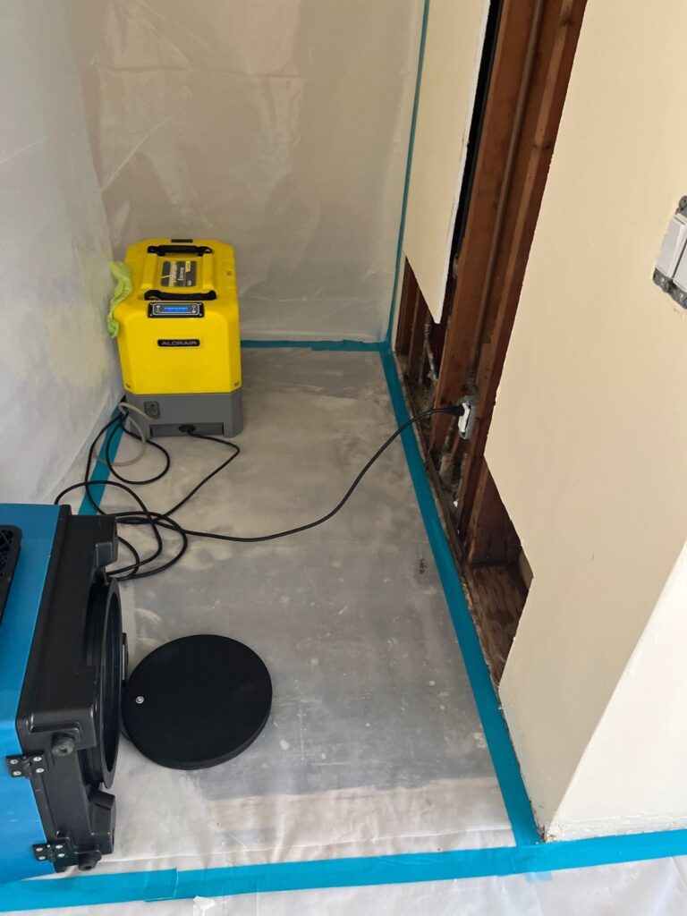 Plastic containment and equipment set up in a room during bathroom mold remediation in Ventura
