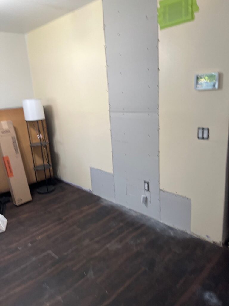 New drywall patches on walls that were opened during mold remediation
